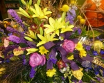 Casket spray in purples and yellows